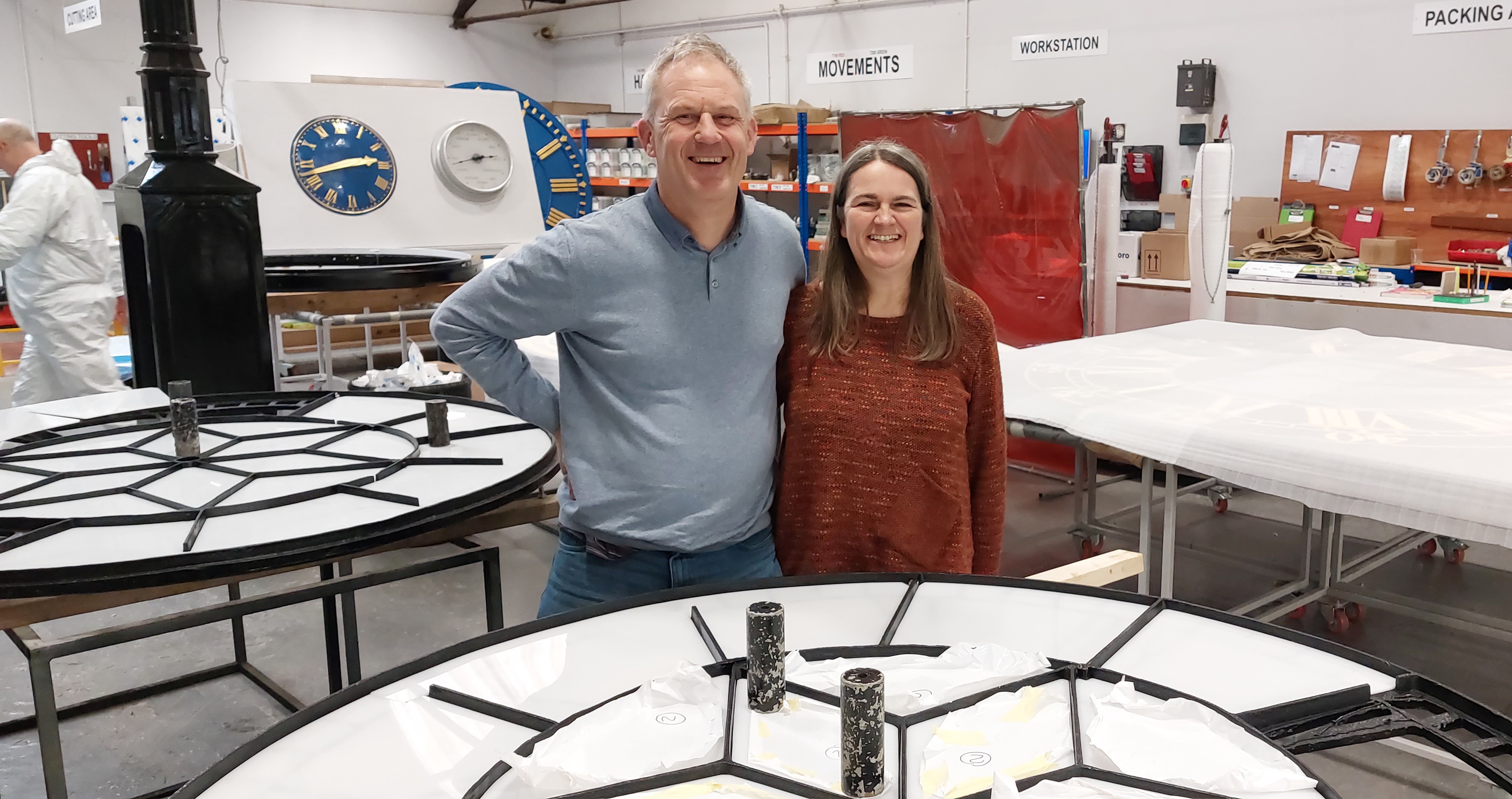 Martin and Michelle standing with the Maison Dieu clock