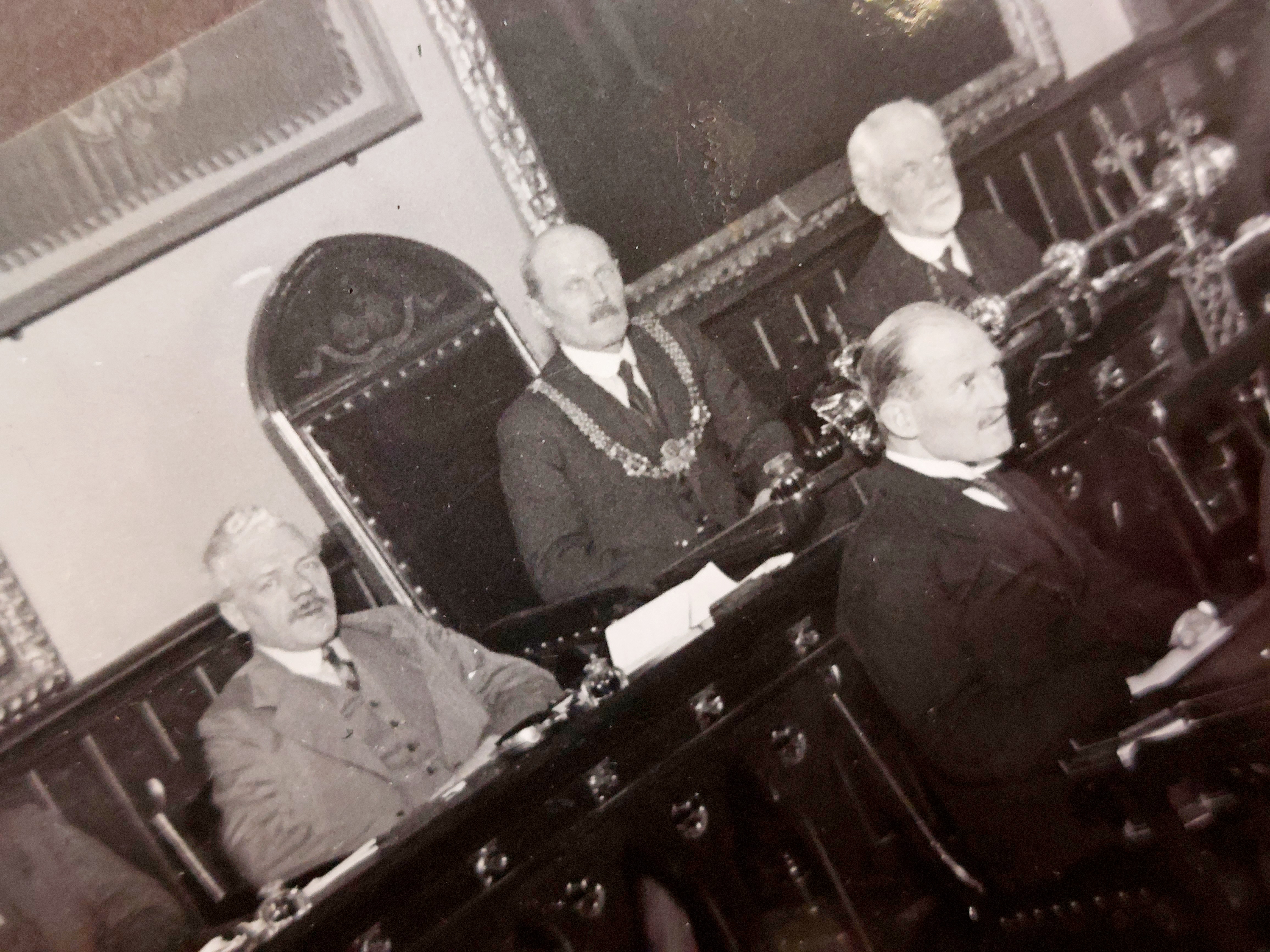 Close up showing the mayoral chain and Dover’s 17th century silver-gilt mace. Close up black and white photo of Dover Town Council seated in the Council Chamber at the Maison Dieu. showing the the mayoral chain and Dover’s impressive 17th century silver-gilt mace.