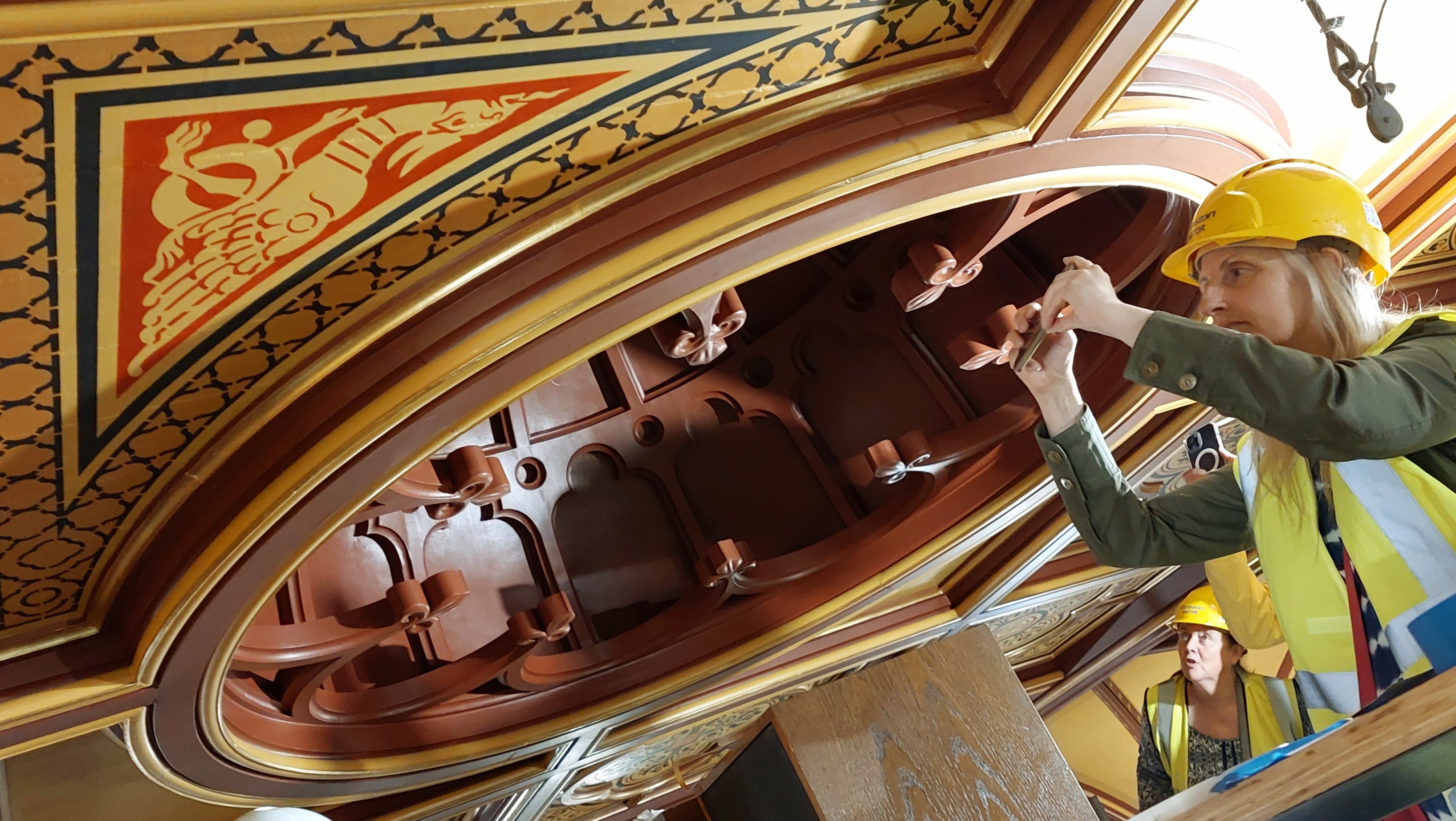 One of the tour attendees photographing the Victorian sun burner on the ceiling of Connaught hall. 