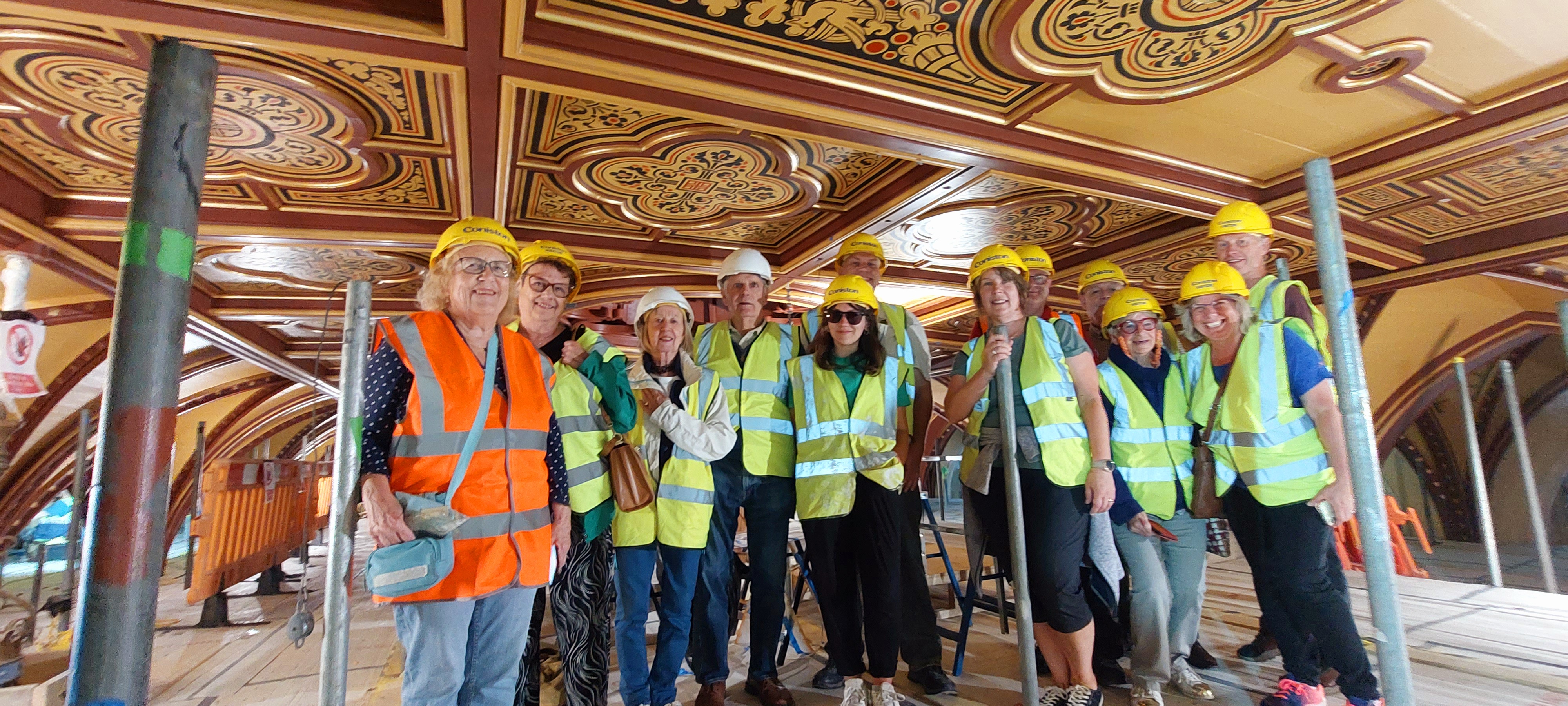 Attendees of a Maison Dieu tour, at the top of the bird's nest scaffolding