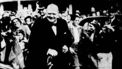 Winston Churchill being greeted by large cheering crowds Black and white photo of Winston Churchill being greeted by large cheering crowds